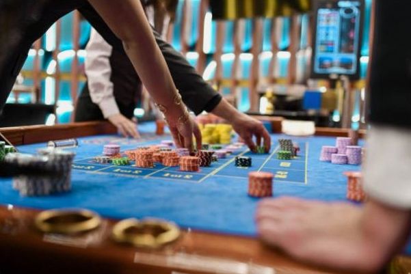 Roulette-style entertainment station lit for an evening event